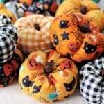 Pile of fabric pumpkins in various fabrics.