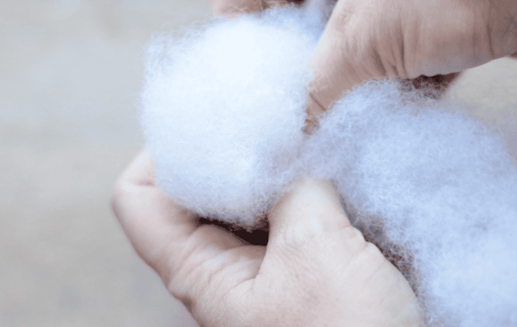 Sock being stuffed with pillow stuffing.