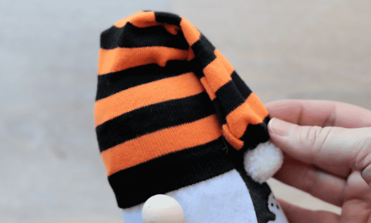 Striped sock on top of gnome.