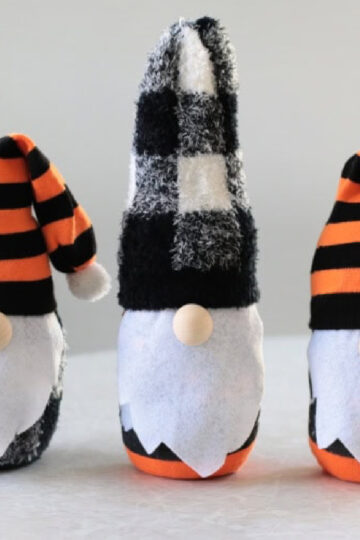 Three Halloween themed sock gnomes on a table.