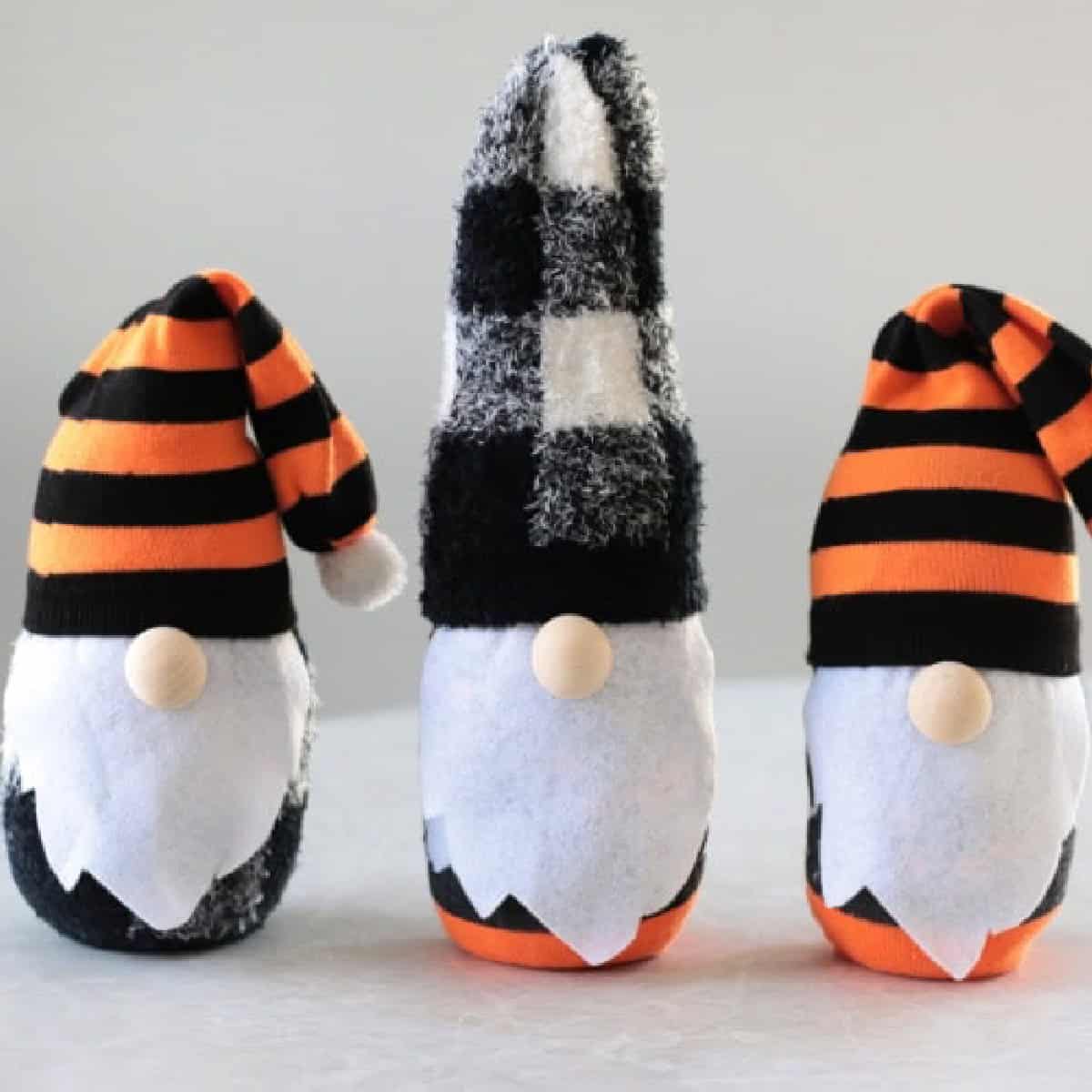 Three Halloween themed sock gnomes on a table.