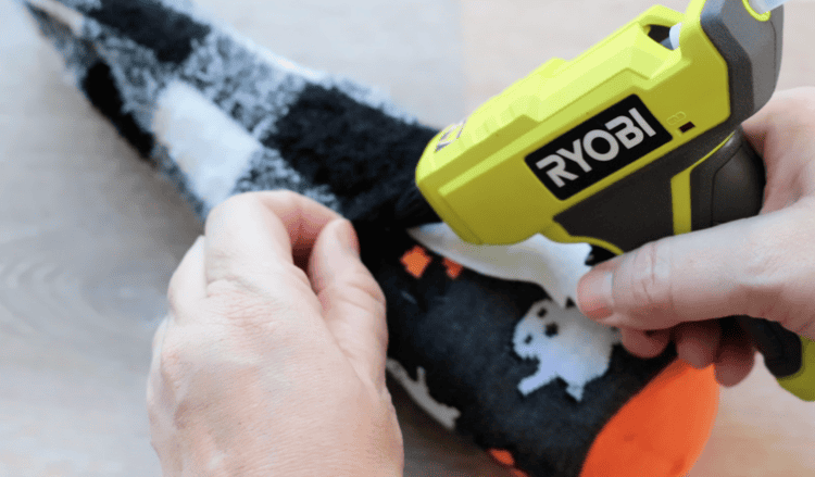 Hat being hot glued to gnome.