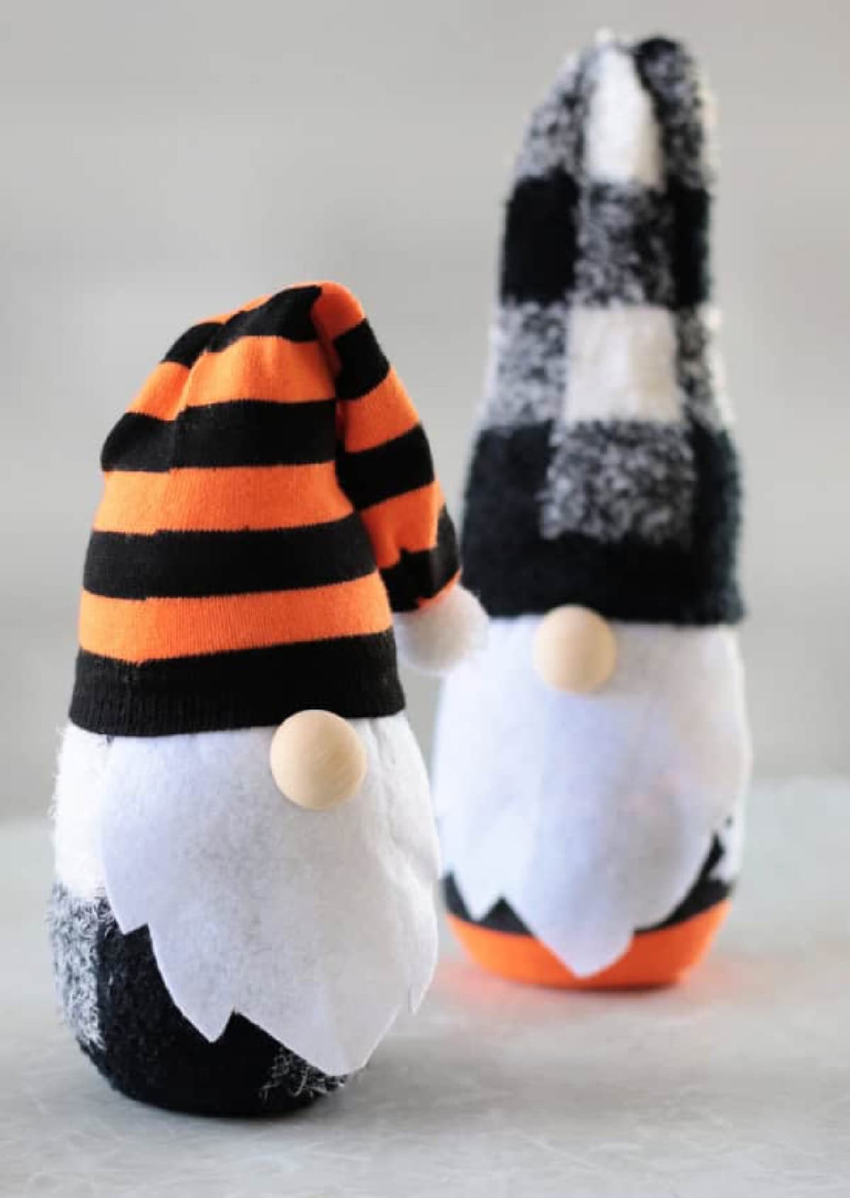 Two sock gnomes on a table.