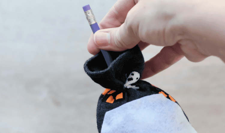 Pencil sticking out of sock gnome top.