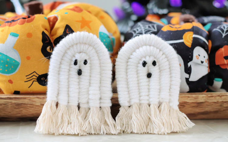 two macrame pumpkins next to fabric pumpkins