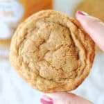 Hand holding pumpkin snickerdoodle cookie.
