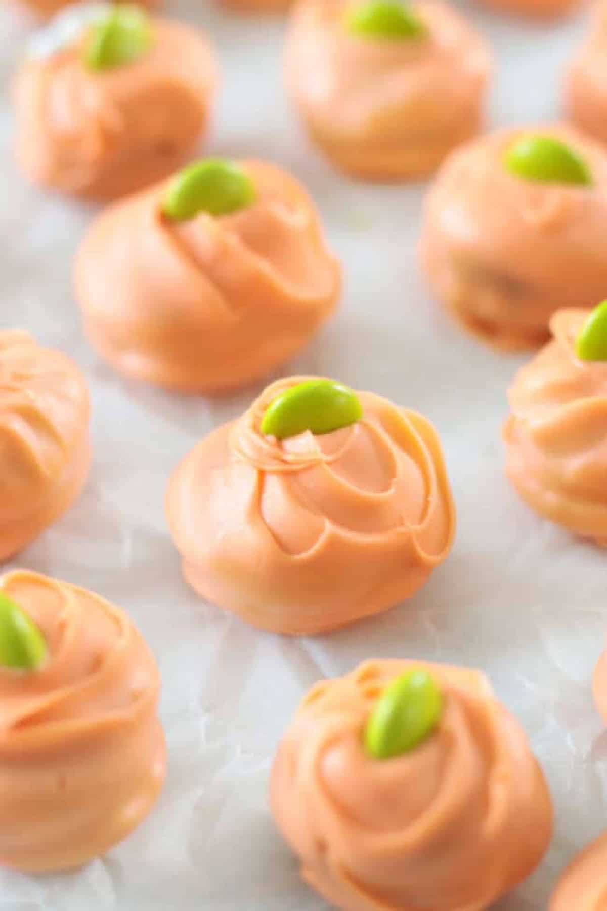 Reese's pumpkin bites on parchment paper.