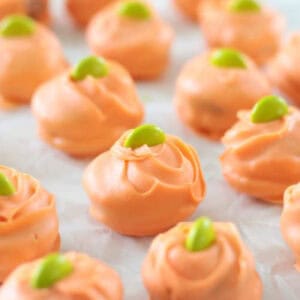 Reese's pumpkin bites on parchment paper.