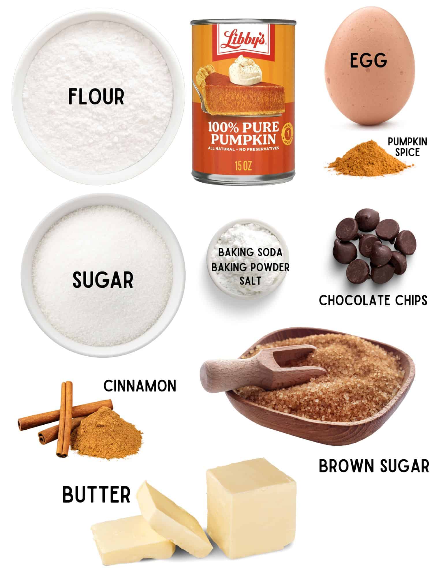 Bowls of flour, sugar, baking soda, baking powder and salt, chocolate chips, piles of cinnamon and pumpkin spice, bowl of brown sugar, egg and a stick of butter.