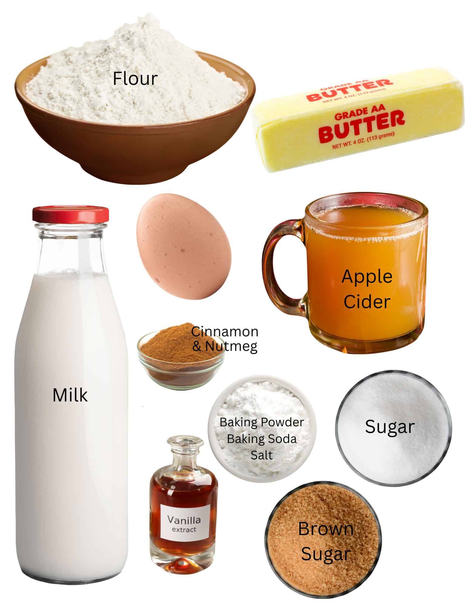 Bowl of flour, stick of butter, apple cider, egg, bowls of cinnamon and nutmeg, bottle of milk, bowls of sugar and vanilla extract.