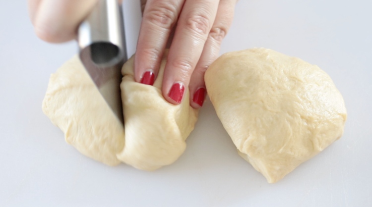 pastry cutter slicing roll dough