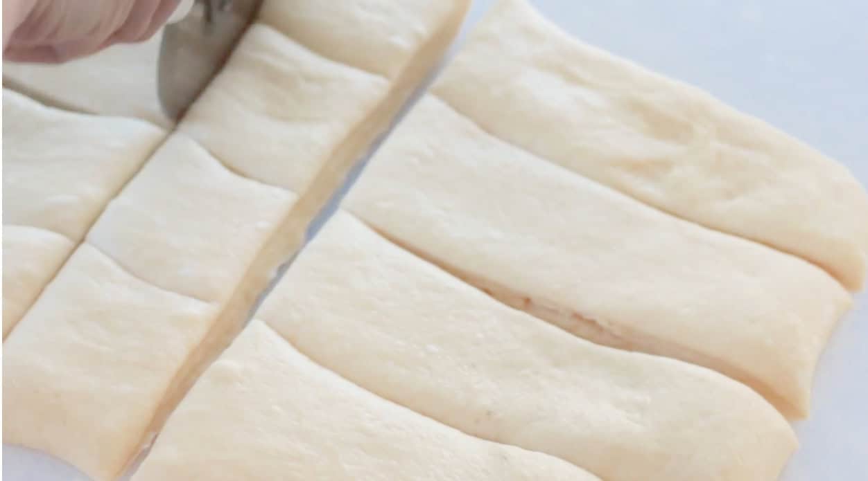 Dough rolled out and sliced with pizza cutter.