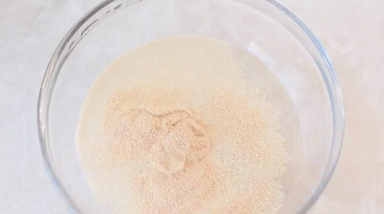 Yeast and water in small glass bowl.
