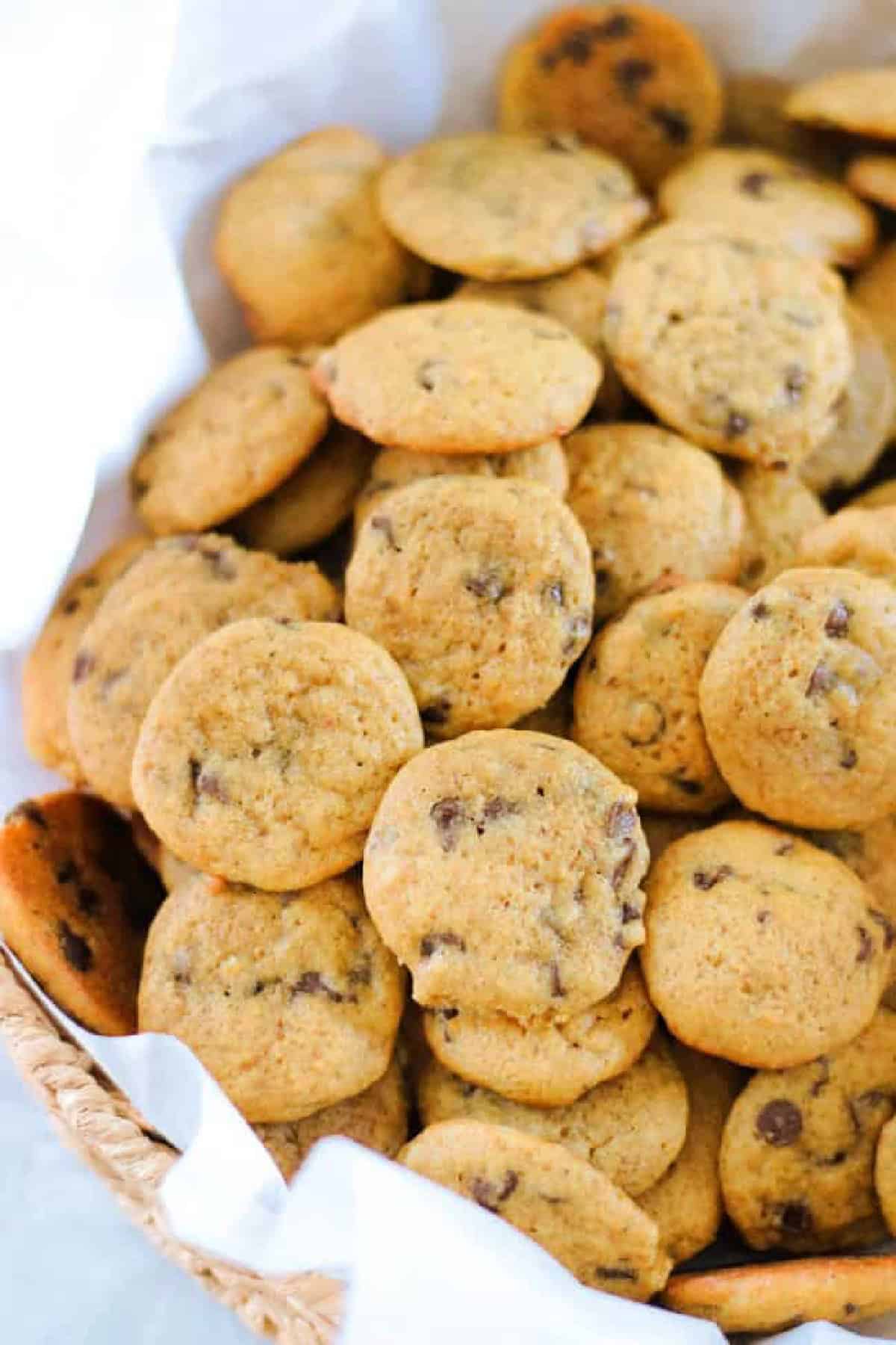 Basket of mini pumpkin chocolate chip cookies.