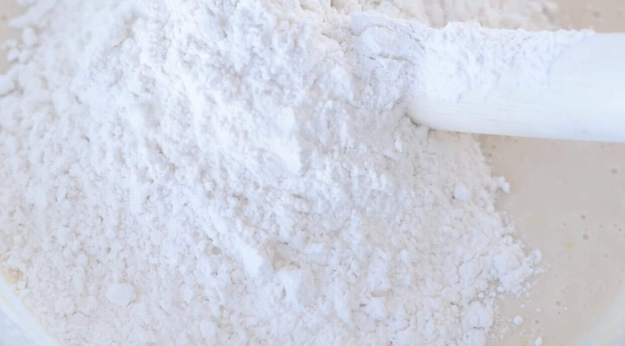 Flour in mixing bowl with Danish dough whisk.