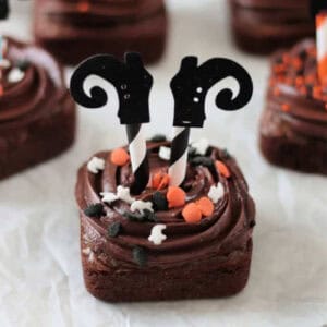 Square brownie with straw witch legs.