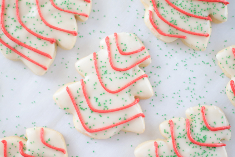 white sugar cookies with red drizzle and green sprinkles.