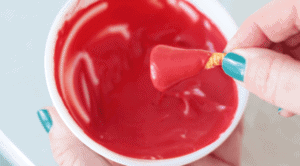 bugle dipped in bowl of red candy melts