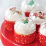 red cake platter with cupcakes on top