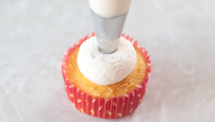 vanilla buttercream piped onto cupcakes