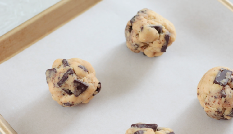 balls of cookie dough on baking sheet with parchment paper