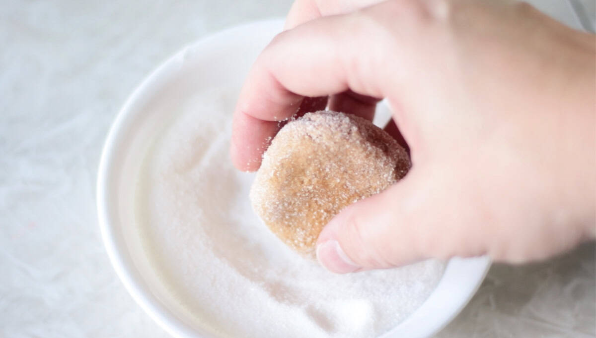 Ball of molasses cookie dough rolled in granulated sugar.