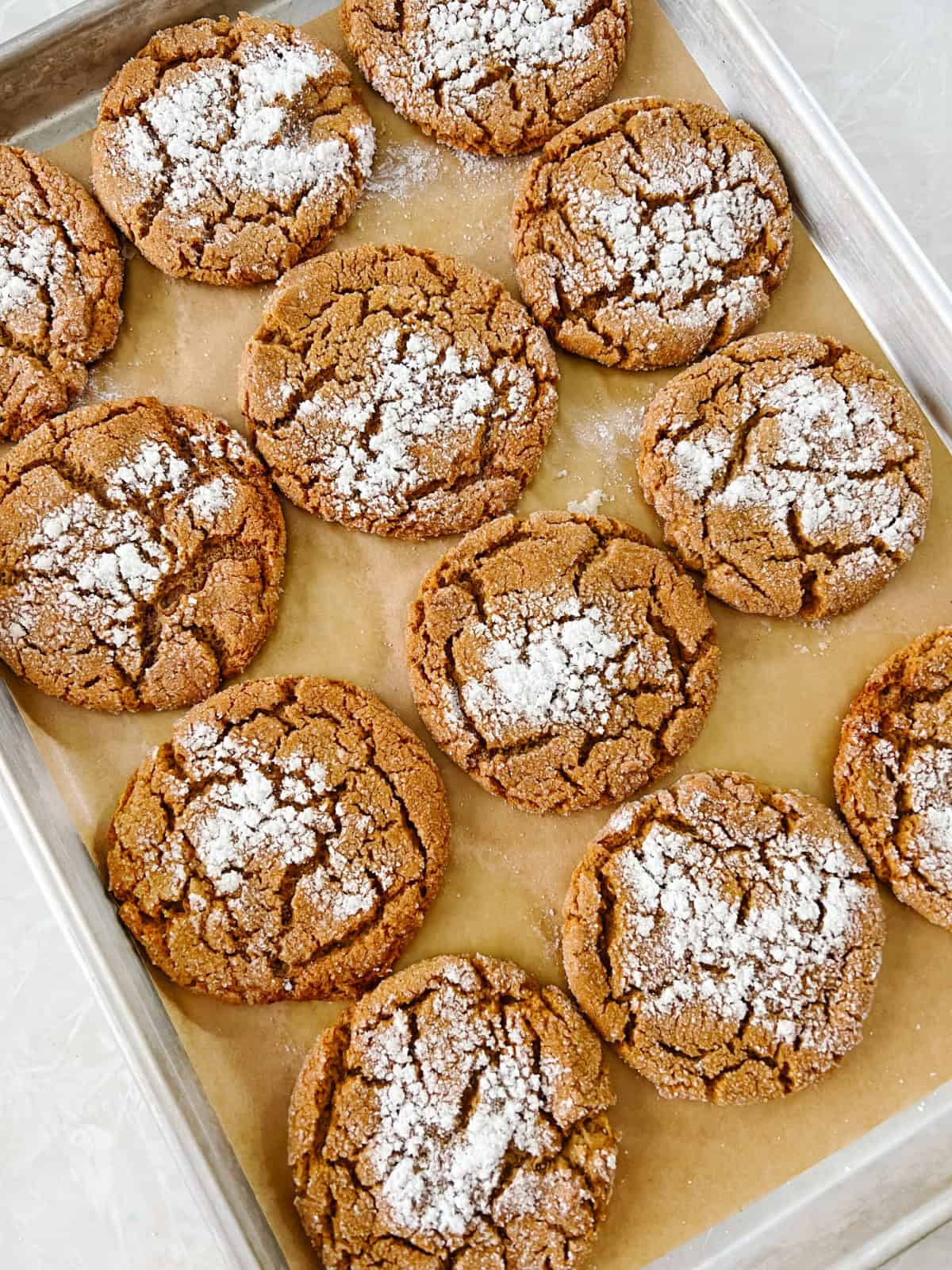 Baking sheet with parchment paper and cookies.