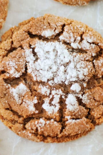 Molasses cookie on parchment paper.