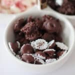 White bowl of chocolate nonpareils candy.