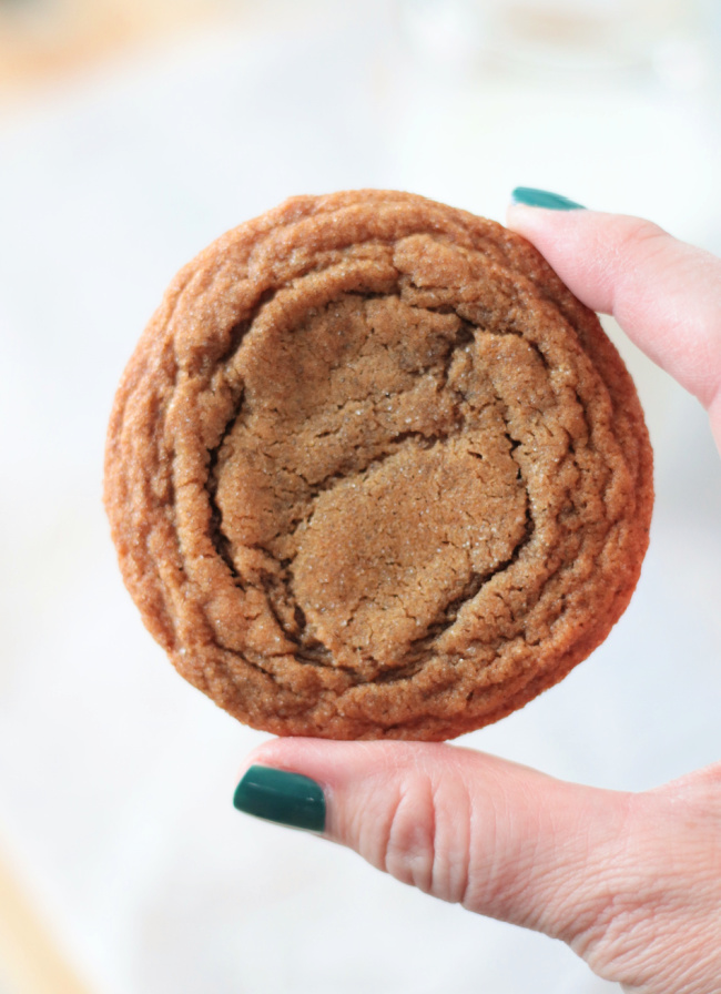 hand holding ginger molasses cookie