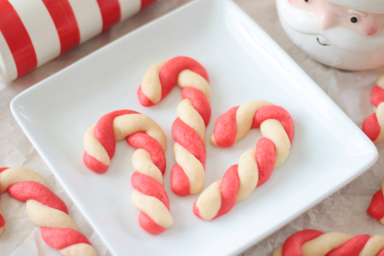 3 candy cane sugar cookies on a plate