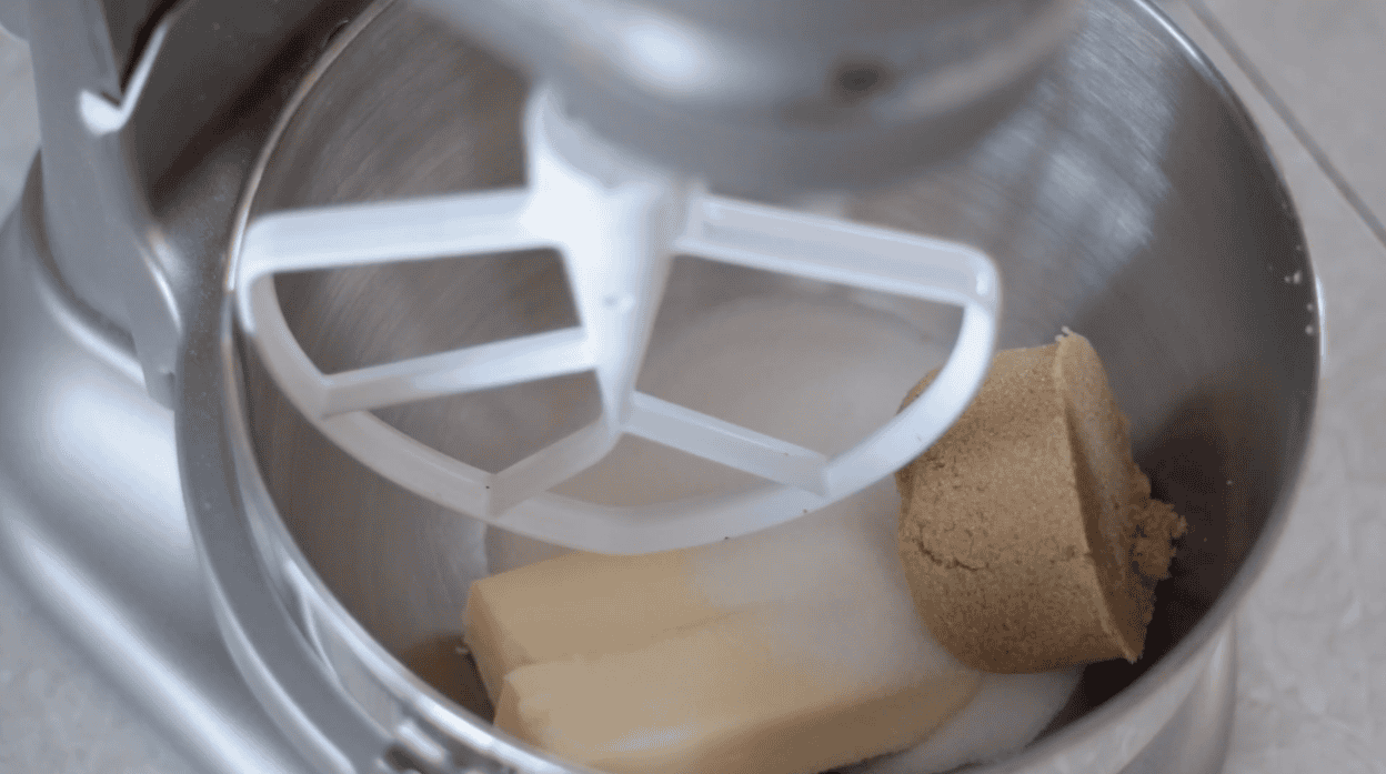 Stand mixer bowl with butter and sugars.