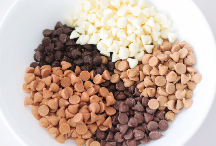 five types of chocolate chips in a bowl