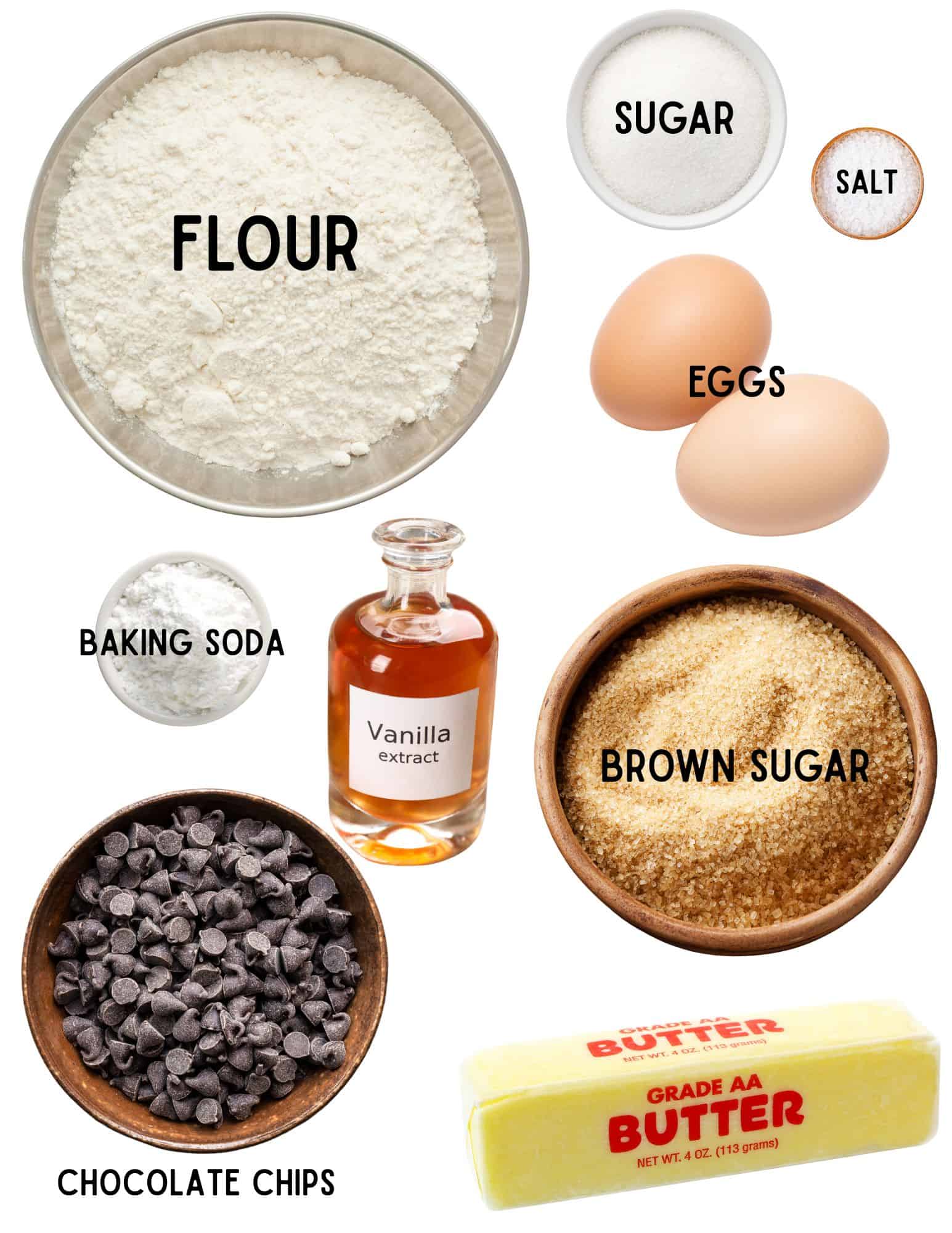 Bowls of sugar, flour, baking soda, salt, brown sugar, chocolate chips, butter, vanill and eggs.