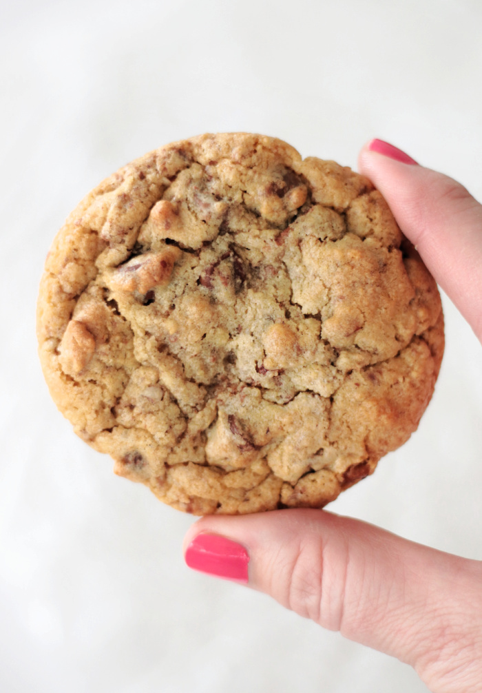 hand holding Neiman Marcus chocolate chip cookie
