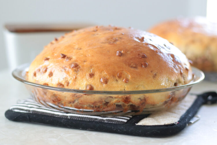 loaf of cinnamon chip bread in pie pan