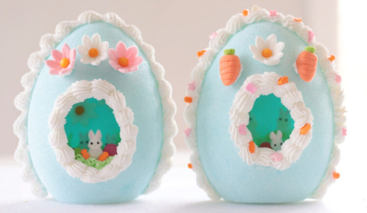 two pale blue panoramic sugar eggs with bunny decorations