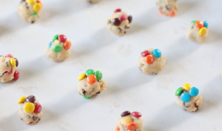 tiny cookie dough balls on baking sheet