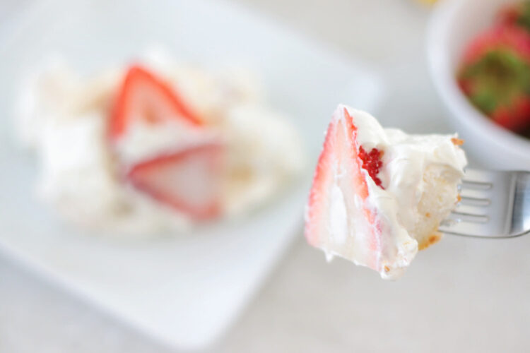 fork with strawberry, cream and cake