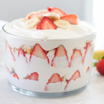 strawberry banana trifle layered in glass bowl