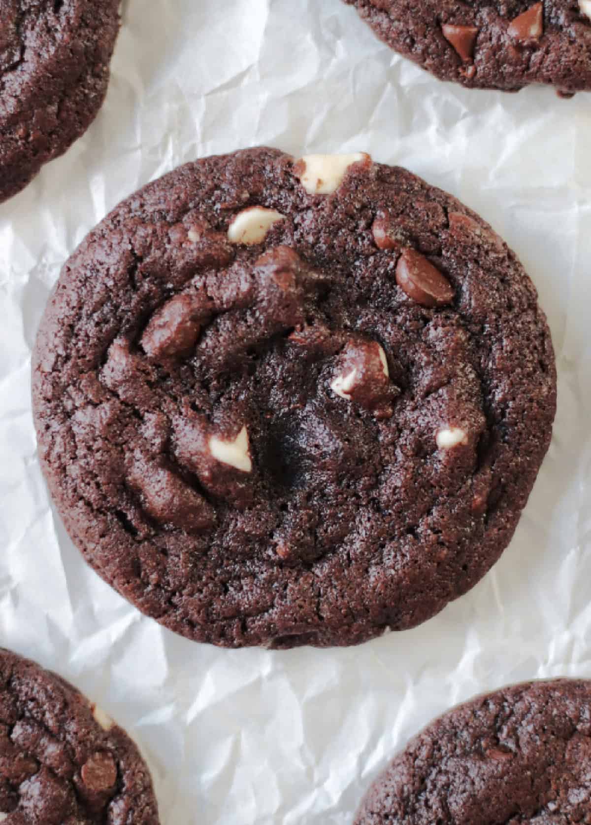 Double chocolate chip cookies on parchment paper.