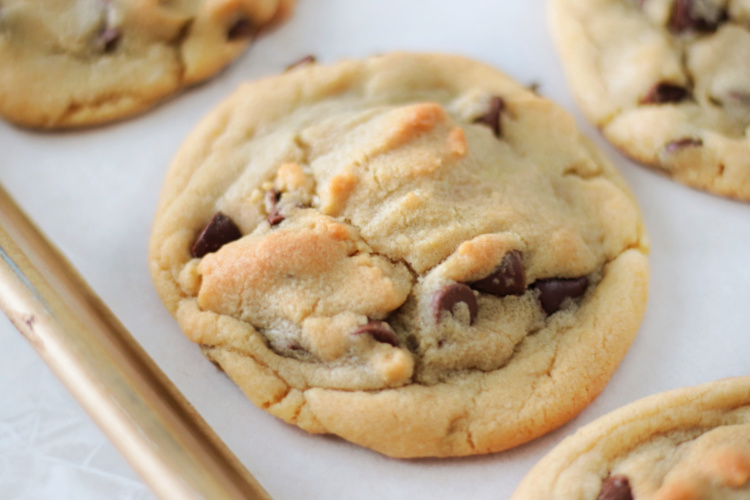 tray of chocolate chip pudding cookies, baked on parchment paper.