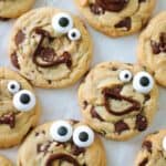 chocolate chip cookies with melted chocolate faces and candy eyes