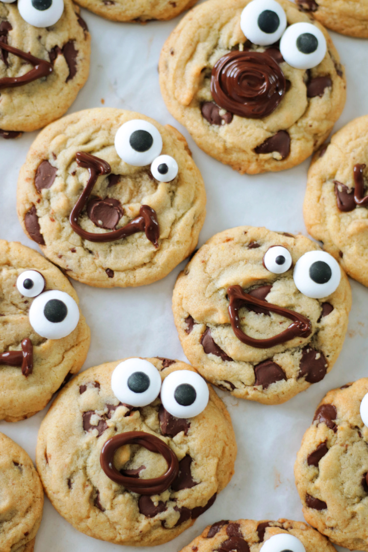 chocolate chip cookies with melted chocolate faces and candy eyes