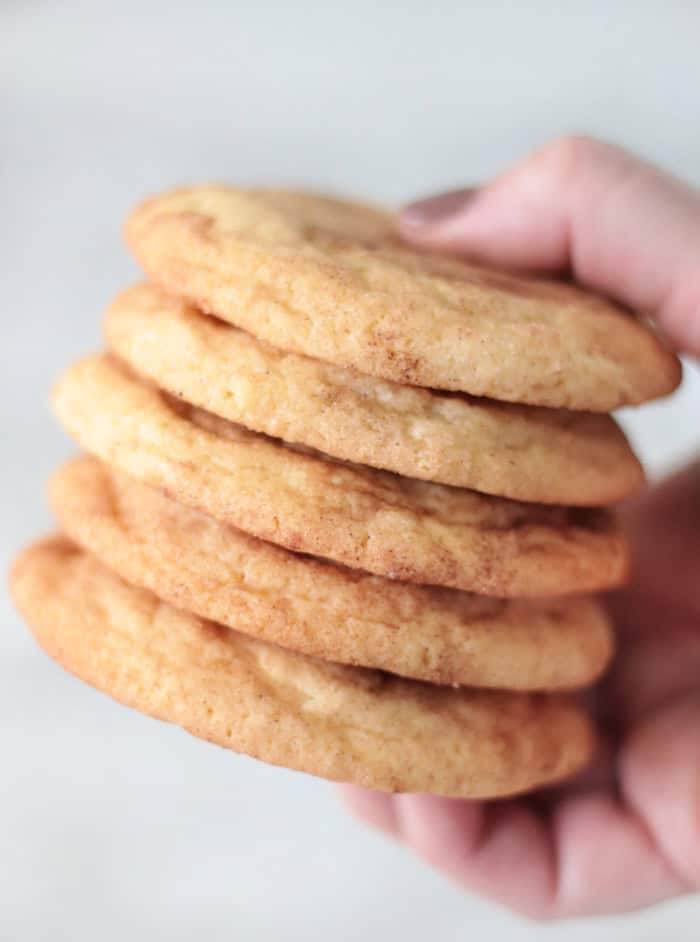 hand holding stack of snickerdoodles