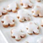 Iced gingerbread man cookies on a baking sheet.
