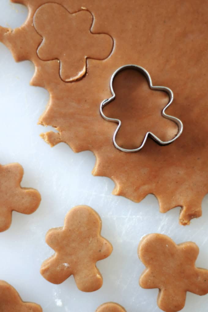 gingerbread cookie dough rolled out and cut with cookie cutter.