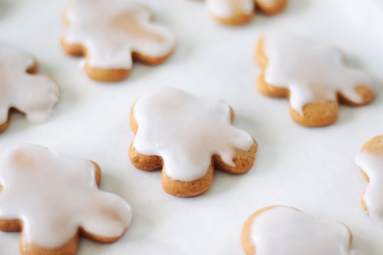 iced gingerbread man cookies on parchment paper.