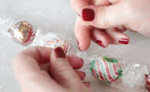 hands tying fishing line to cellophane