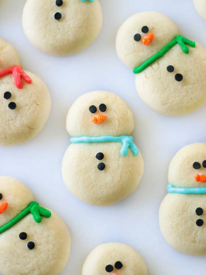 Chubby snowman cookies decorated with frosting.